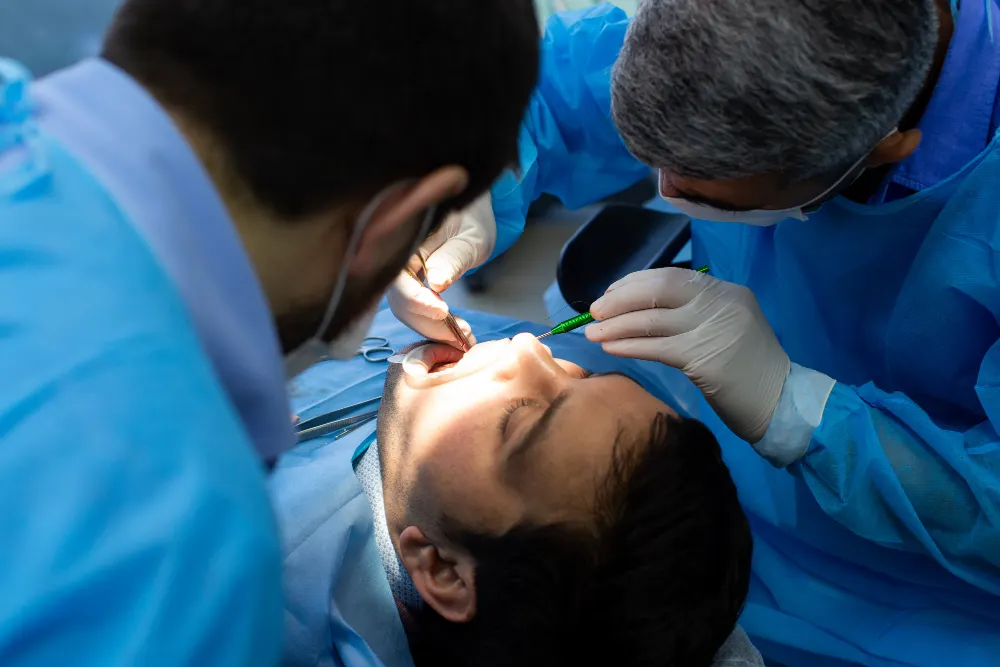 Dentist and assistant examining a patient’s teeth before restorative treatment